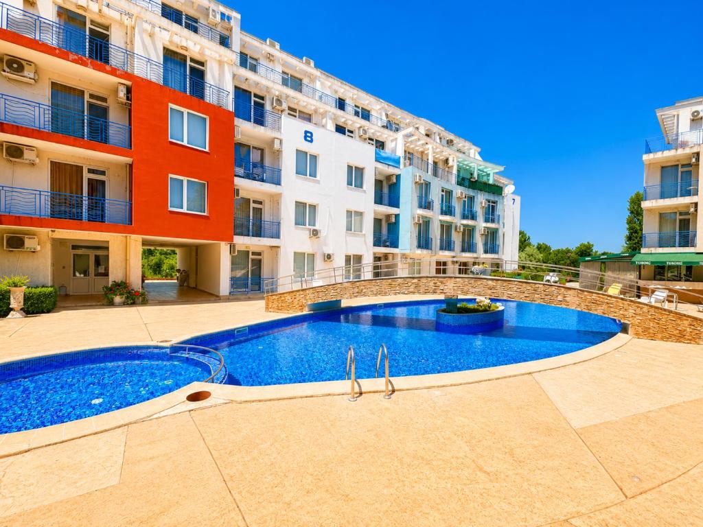 a swimming pool in front of a building at Sunny Day 3 - Pool and Chill in Sunny Beach