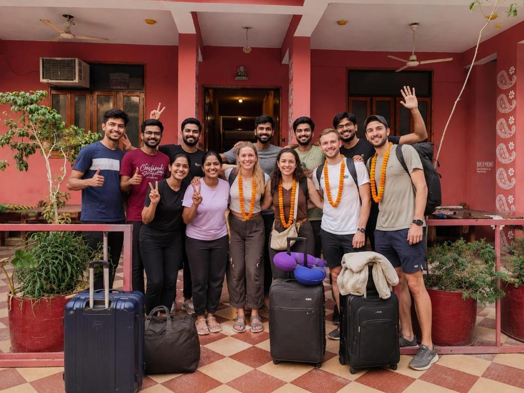 a group of people posing for a picture with their luggage at Cozy Den in Jaipur