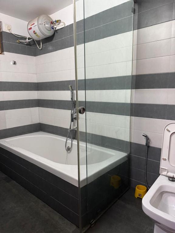 a bathroom with a shower and a bath tub at Raintree Villa in Vythiri