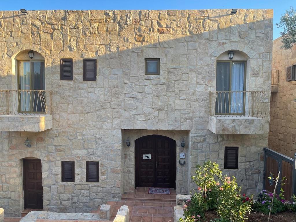 a stone building with a door and windows at Horizon 3 Villa in Amman