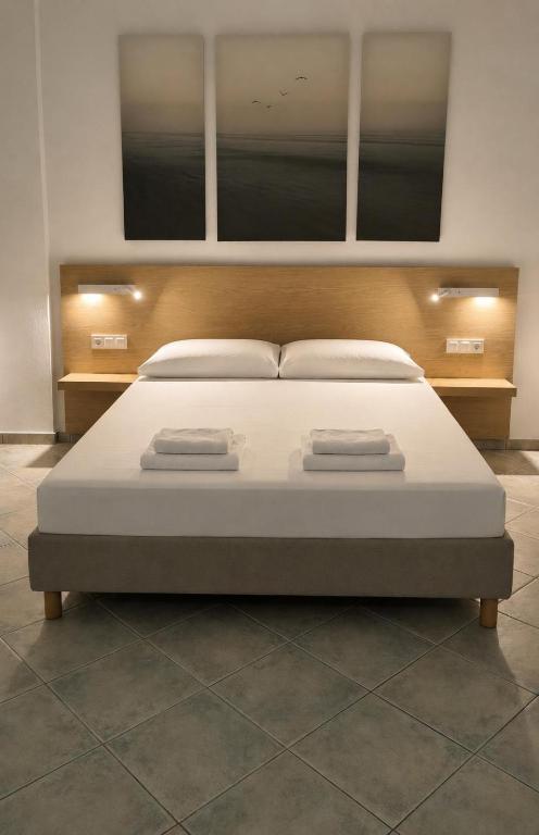 a bedroom with a large bed with two towels on it at Villa Rodanthi Sivota in Syvota
