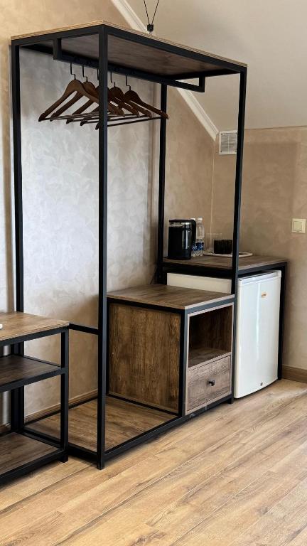a room with a kitchen with a counter and a table at Кристалл in Bosteri