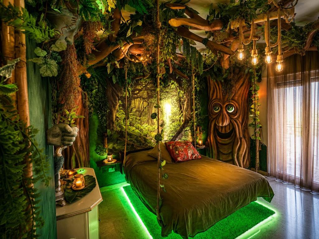 a room with a tree themed bedroom with a swing at B&b Villa Romano in Salerno