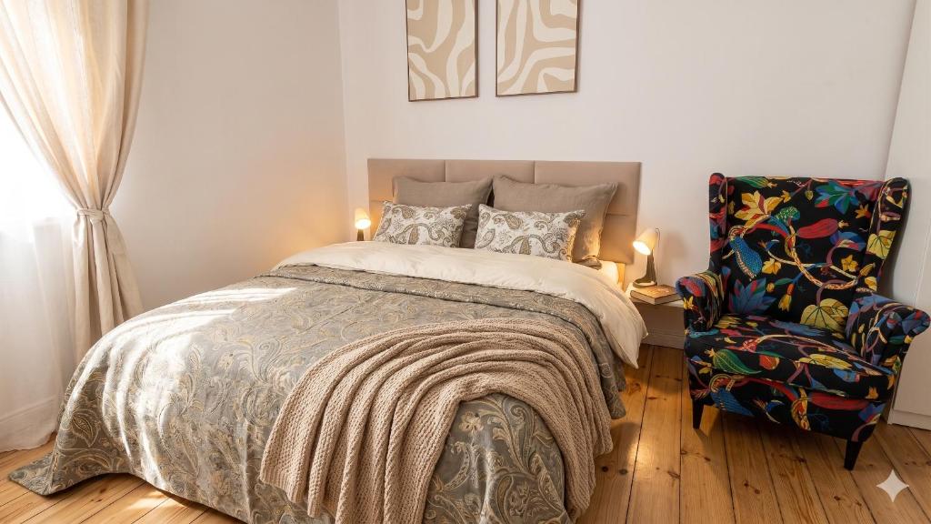 a bedroom with a bed and a chair at G-8HOSTEL Gdynia in Gdynia