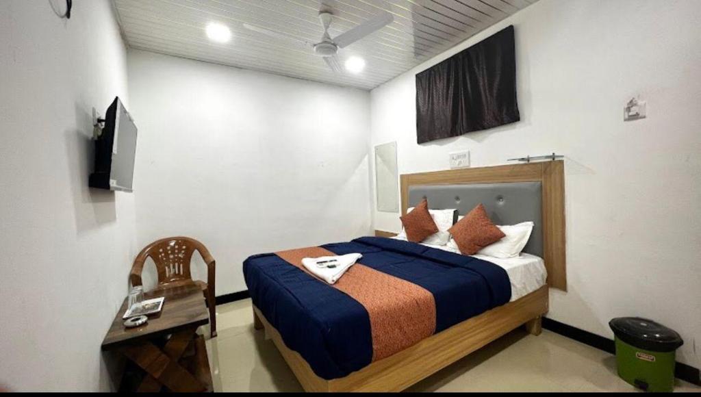 a bedroom with a bed and a television in it at Jazz residency hotel in Mumbai