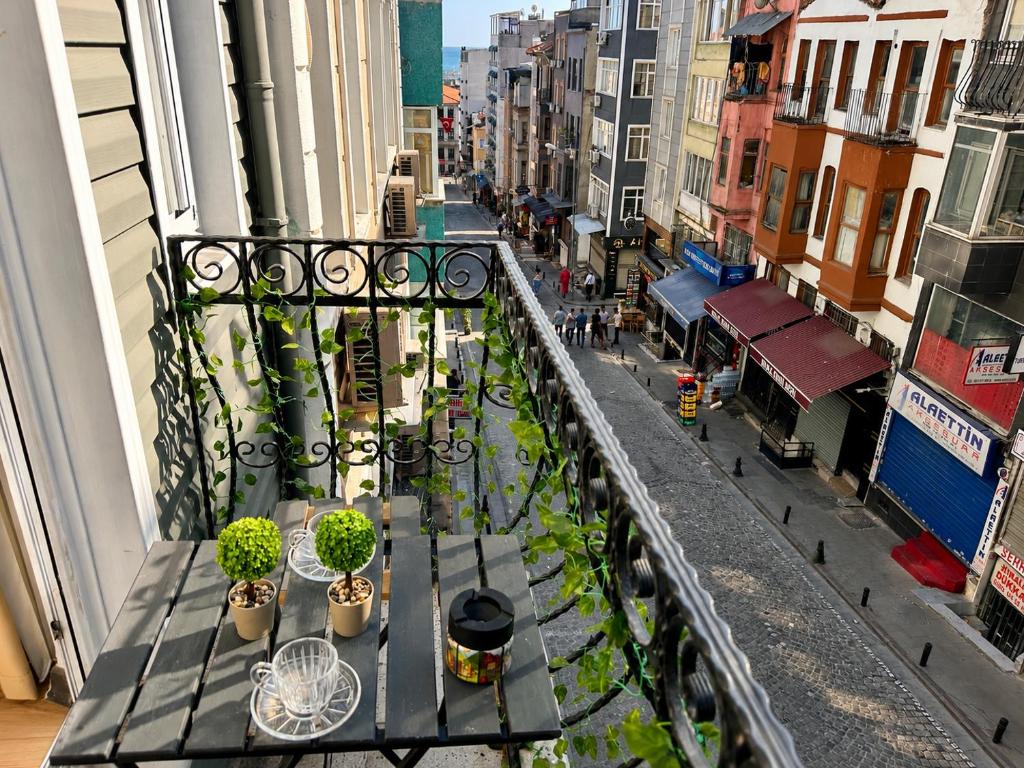 a balcony with a table and potted plants on it at Asil house in Istanbul