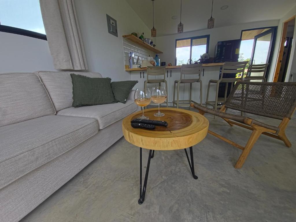 a living room with a couch and a table with wine glasses at Suerte Bella in San Carlos