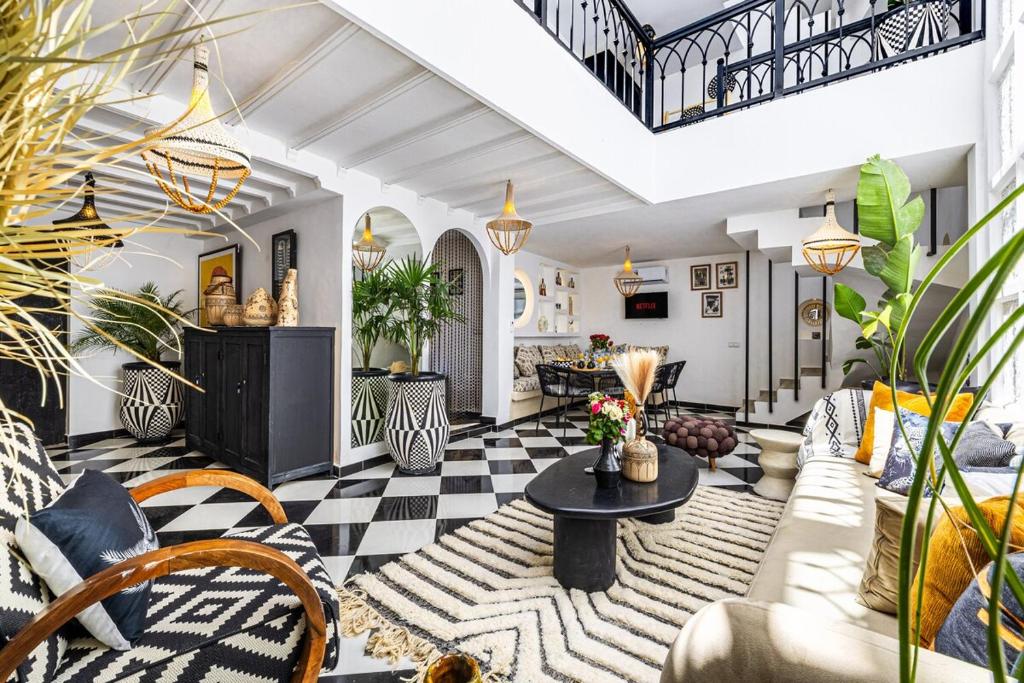 a living room with a couch and a table at Riad Kamil 4Suites - Private Pool - Rooftop Lounge in Marrakesh