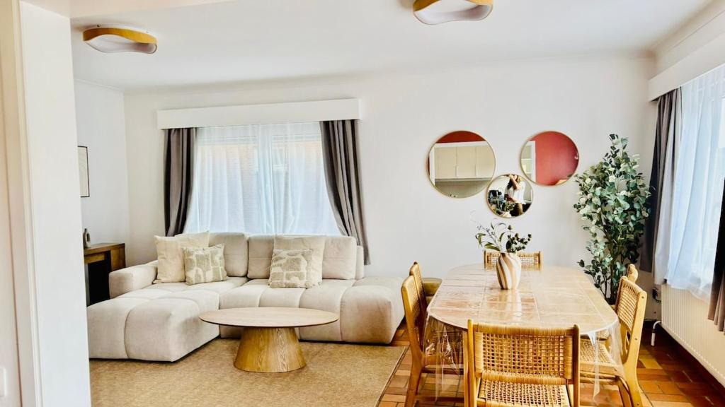 a living room with a couch and a table at Brussels Expo & Atomium Prestige Suites in Grimbergen
