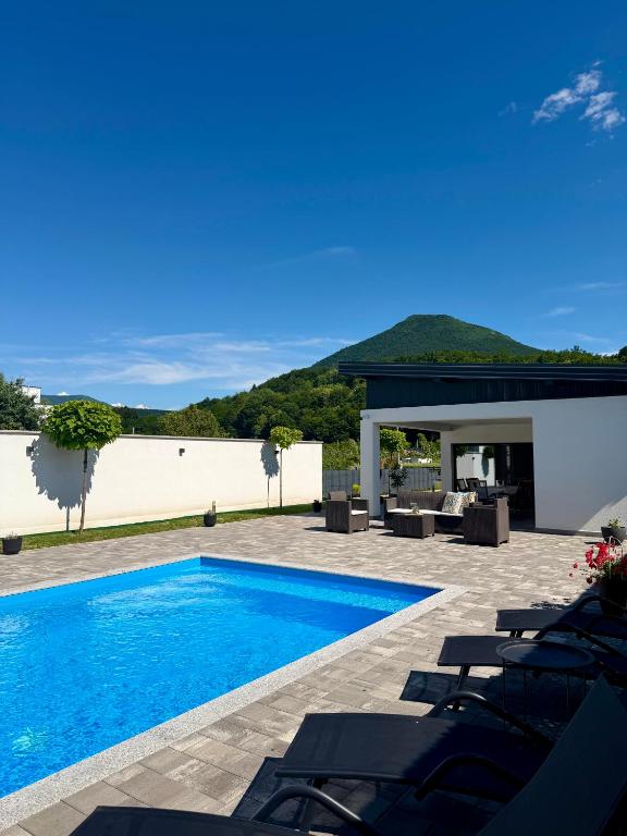 a villa with a swimming pool and a patio at Unavis Residence in Bihać