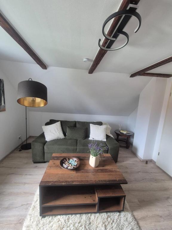 a living room with a couch and a coffee table at Detmolder Perle 2 Charmante Dachgesschoswohnung im Altbau in Detmold