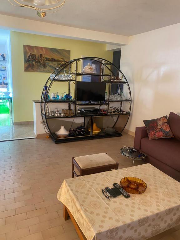 a living room with a couch and a table at Comme chez moi in El Harhoura