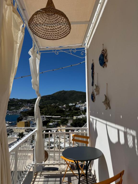 a balcony with a table and chairs and a view at B&B Ponza Suite in Ponza