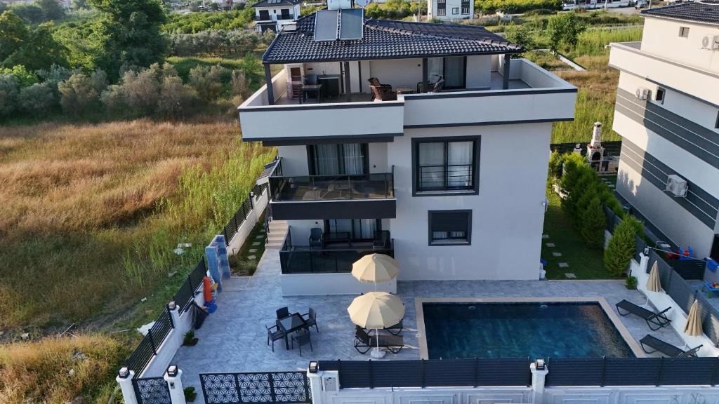 an aerial view of a house with a swimming pool at Villamona Dalaman in Bezkesen