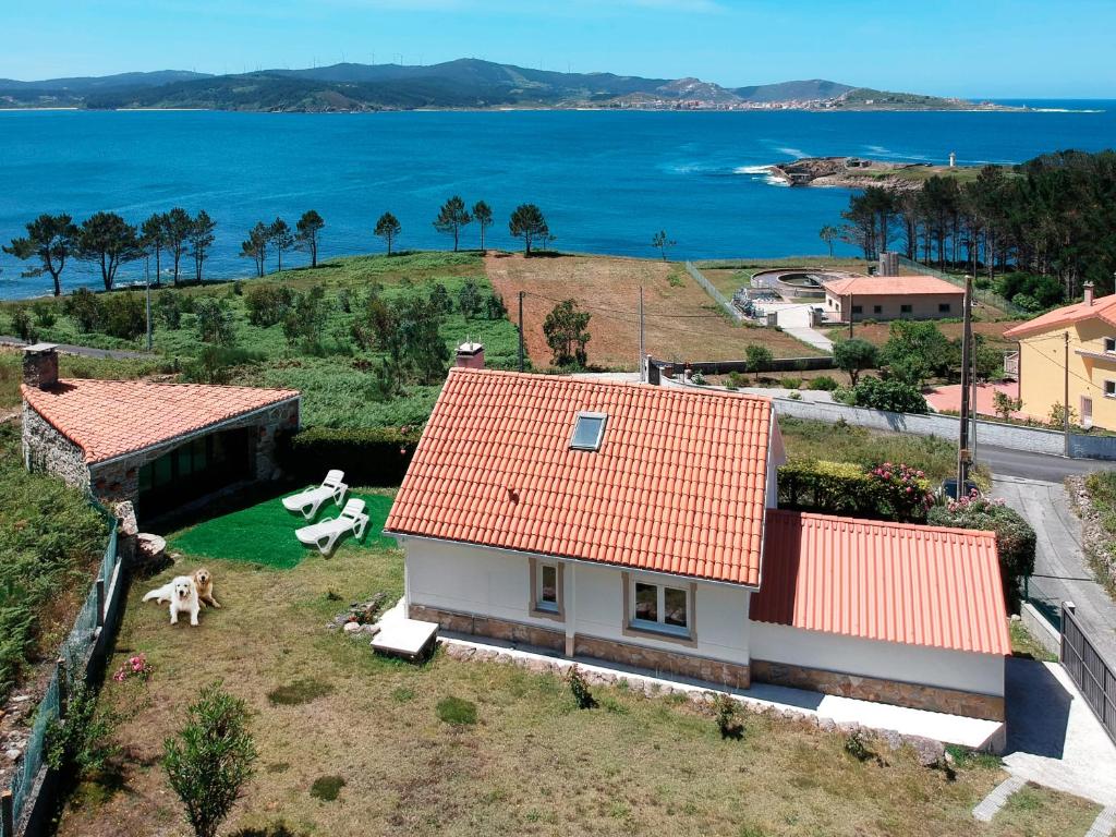 an aerial view of a house with a view of the ocean at AG Casa Camariñas, con jardín y vistas al mar in Camariñas