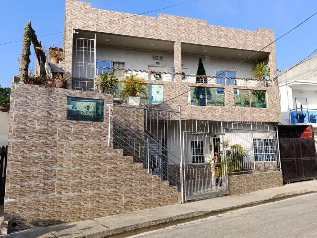 a brick building with a staircase in front of it at APARTAMENTOS LIZ MARIA in Coveñas