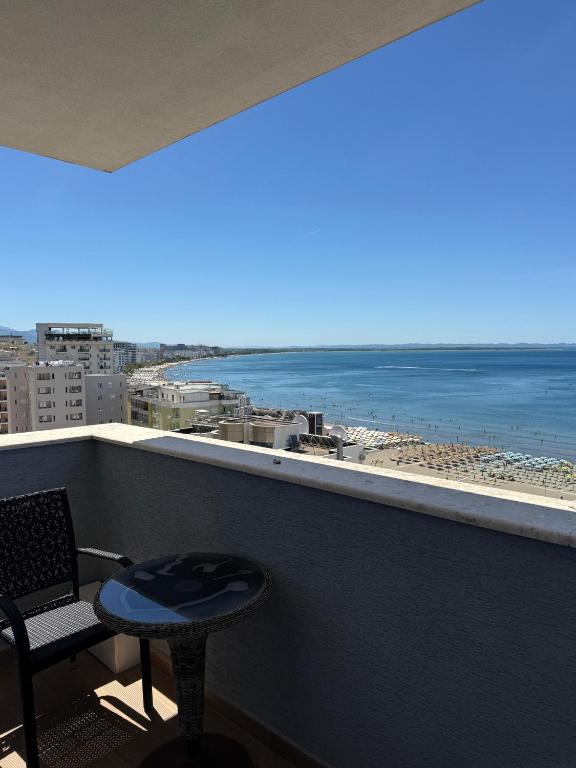 a balcony with a view of the beach and the ocean at Leonard's Shengjin Apartments in Lezhë