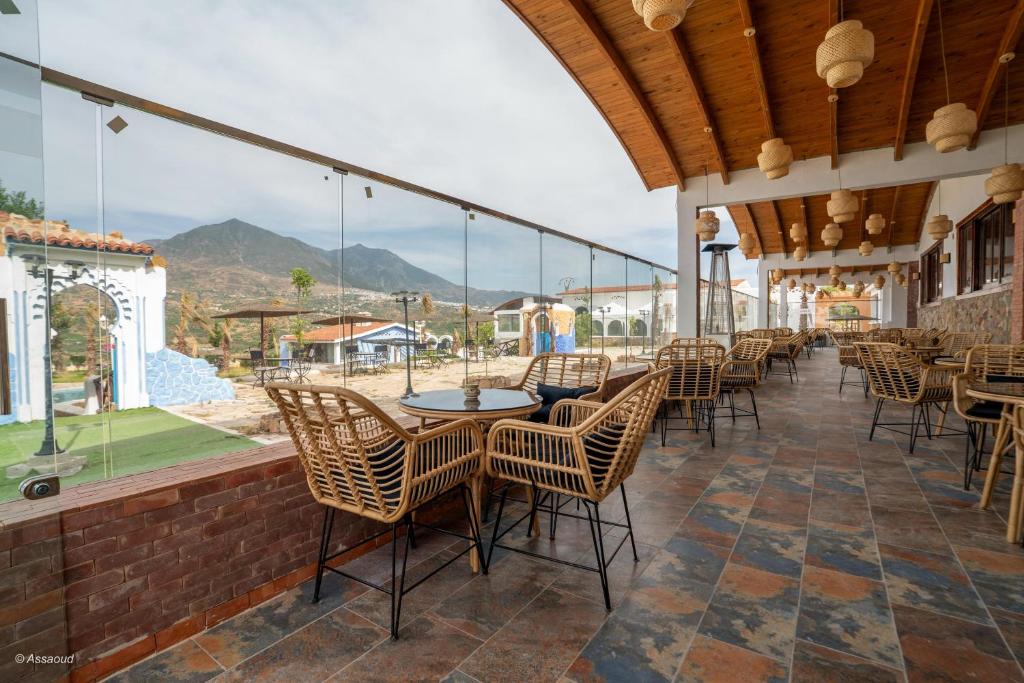 a patio with chairs and tables with a view at Resort Hotel El Cortijo & Spa in Chefchaouen