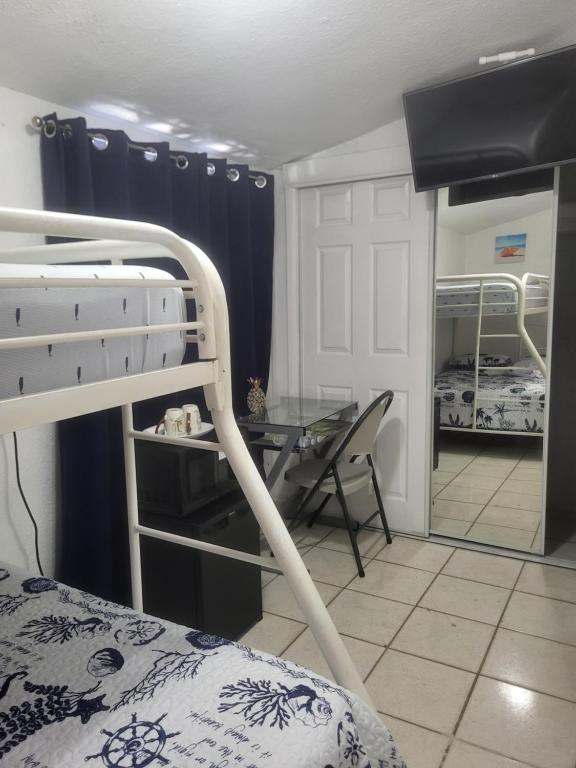 a bedroom with bunk beds and a desk and a table at Coco Sol 1 by MyMiamiStay in Miami