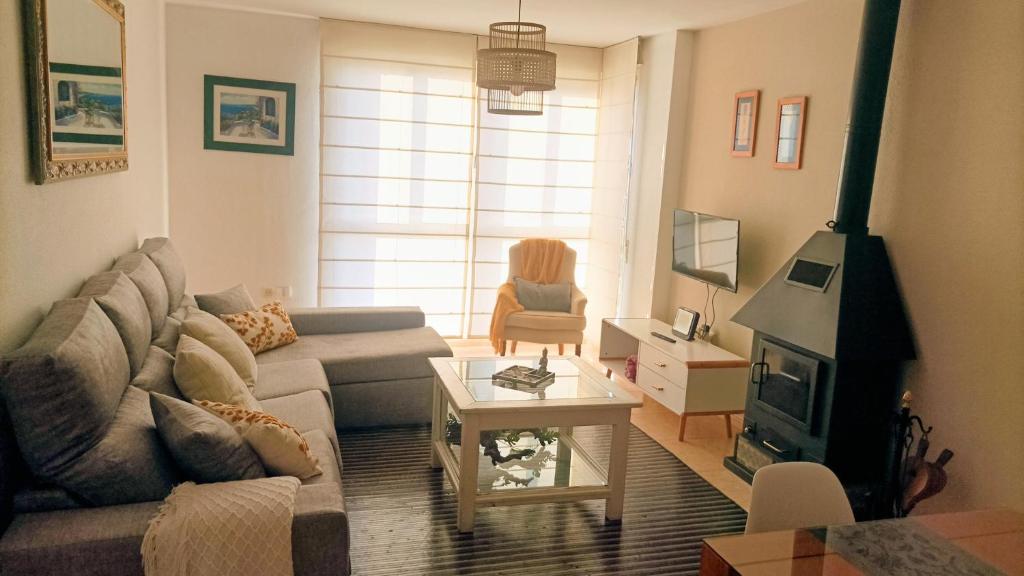 a living room with a couch and a fireplace at Apartamento Belobodia in Cáceres