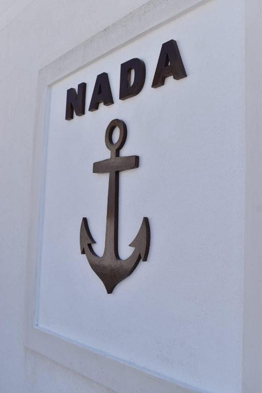 a nada sign with an anchor on a wall at Kuća za odmor Nada in Marina