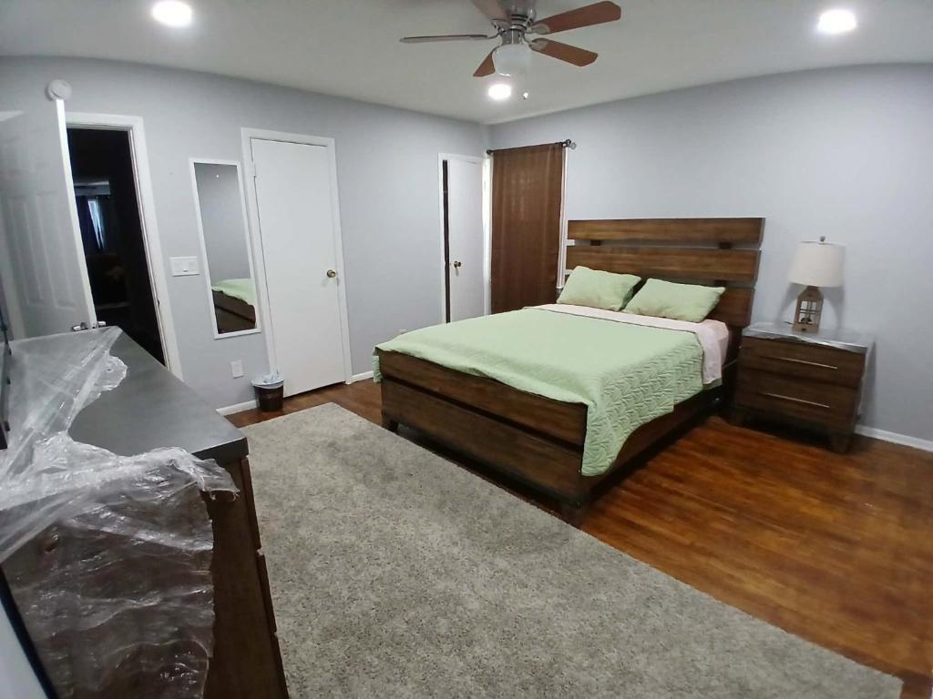 a bedroom with a bed and a ceiling fan at 16 sycamore rd in Bayonne