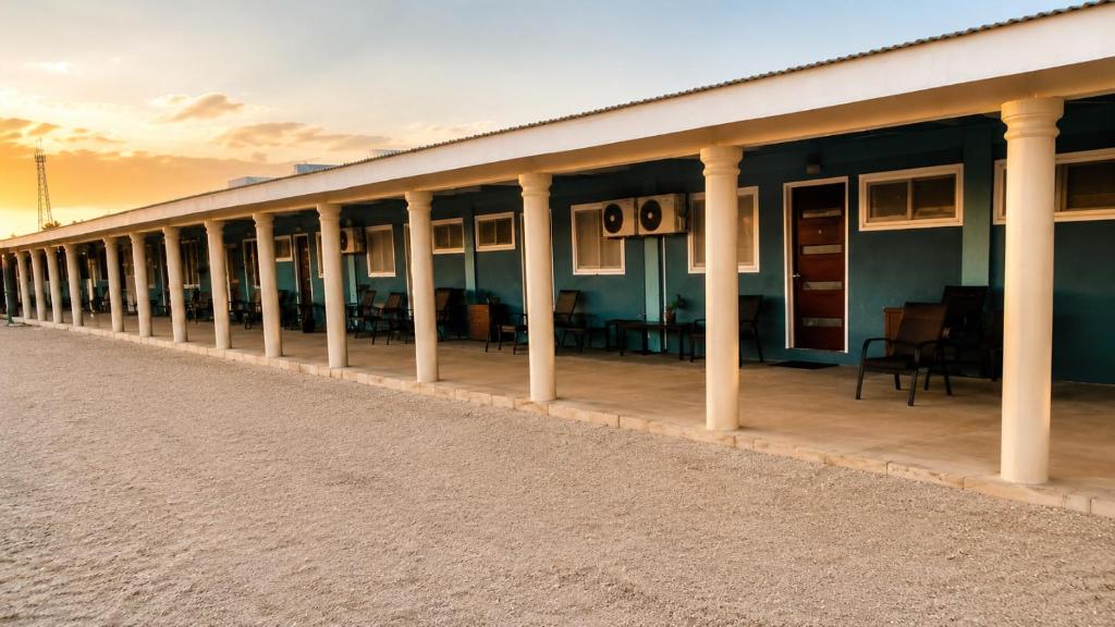 a long building with columns and tables on it at Toafa Lodge - 'Eua Island in ‘Ohonua