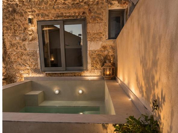 a bath tub in a building with a window at ArKa in Chania