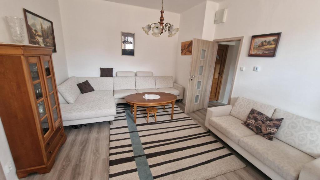 a living room with a couch and a table at Apartment LAURA in Žilina