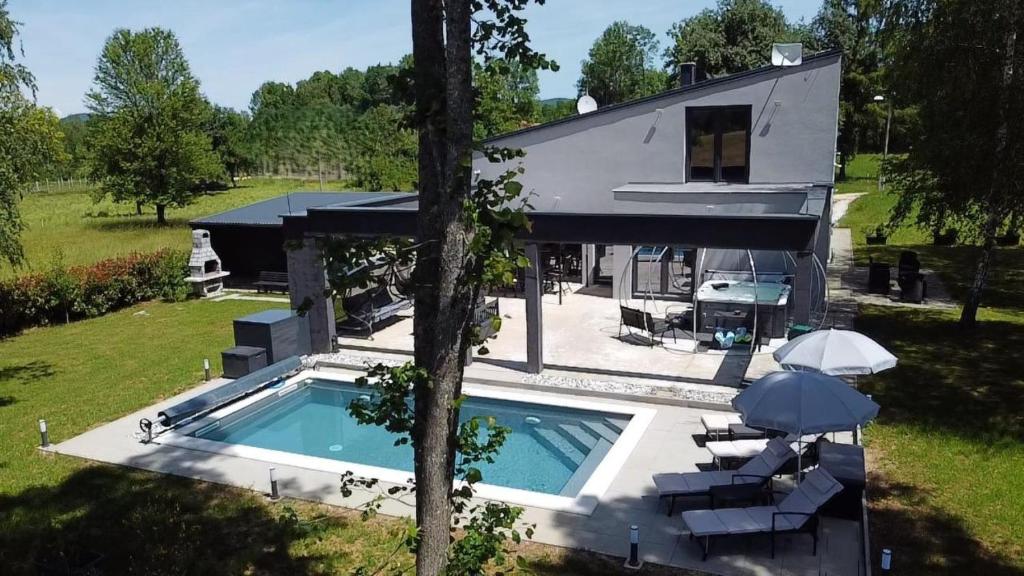 an aerial view of a house with a swimming pool at Country house Greenfields in Gospić