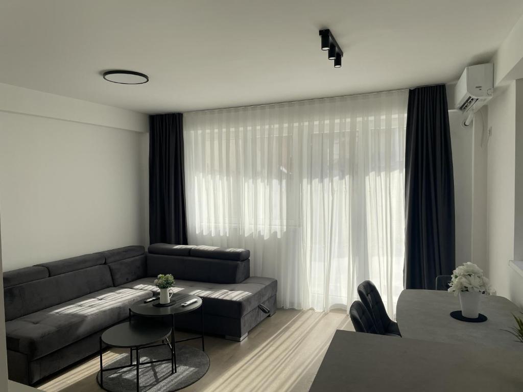 a living room with a couch and a table at BD Luxury Apartment in Bitola