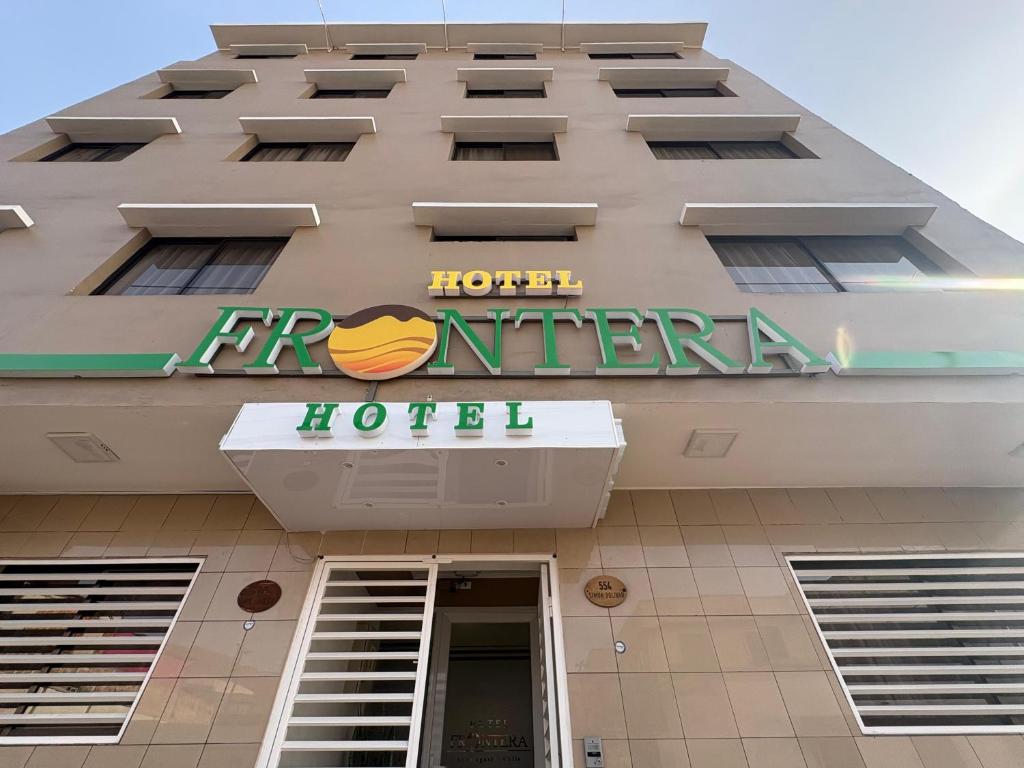 a hotel sign on the side of a building at Hotel Frontera in Antofagasta