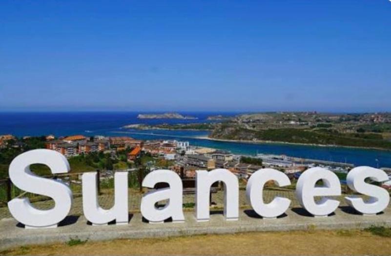 a large sign that reads success in front of a city at Apartamento Sol in Suances
