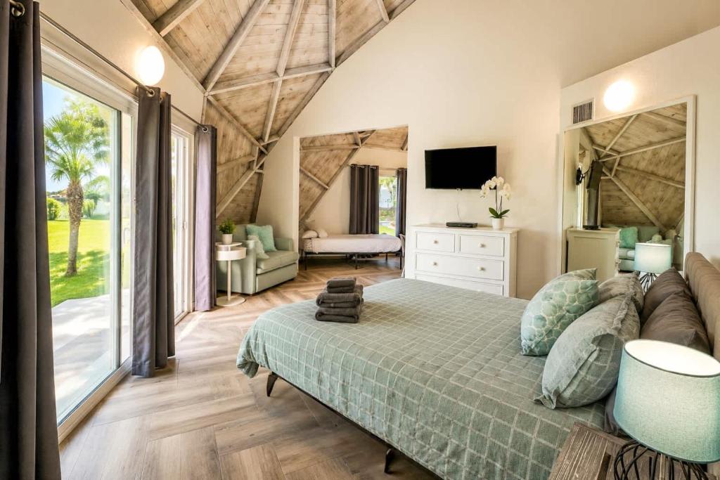 a bedroom with a large bed and a television at STUDIO 05 - Lake Sumner in Clermont