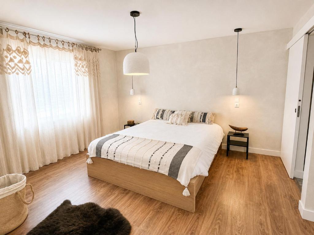 a bedroom with a bed and a cat laying on the floor at Retiro São Pedro House in Aldeia da Mata