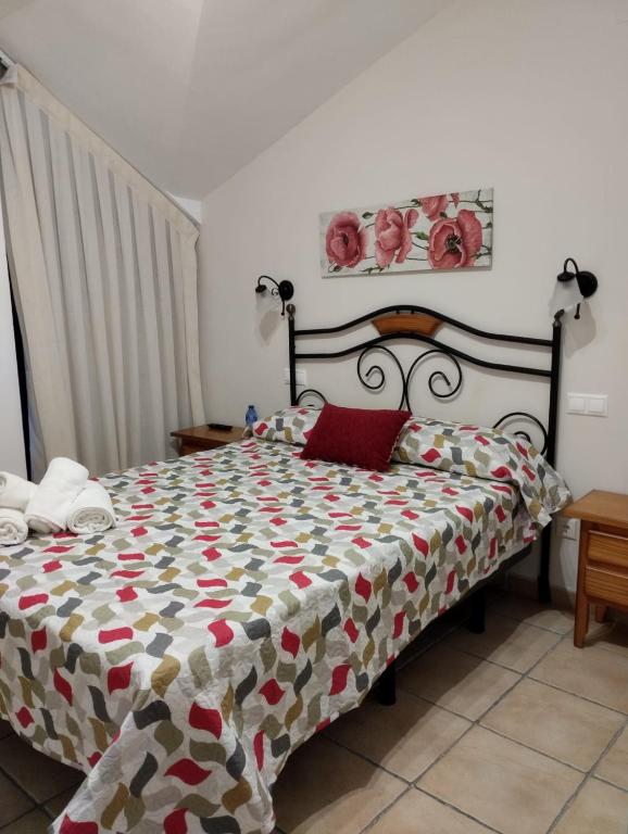 a bedroom with a bed with a quilt on it at Hostal Posada Royuela in Royuela