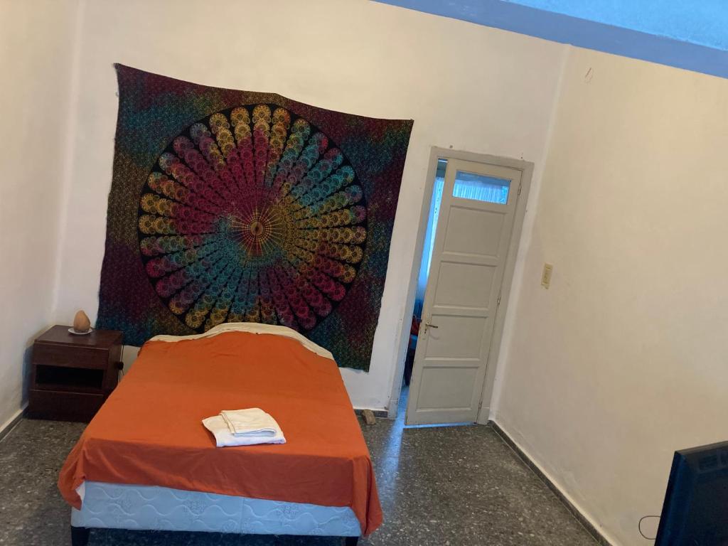 a room with a bed with a painting on the wall at Habitacion Privada, Single Room in Paysandú