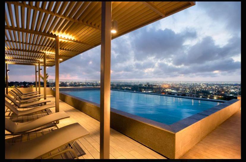 a large swimming pool on top of a building at The Snug Stay - Lennox in Accra