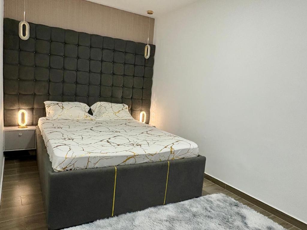 a bedroom with a bed with a headboard and a rug at Appart Angel in Espargos