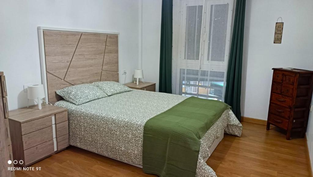 a bedroom with a bed and a large window at DANAGUEST in Los Llanos de Aridane