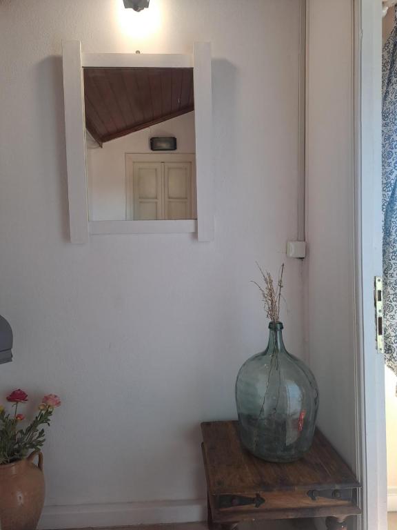 a vase sitting on a table in front of a mirror at Retire Alefkimmon in Lefkimmi