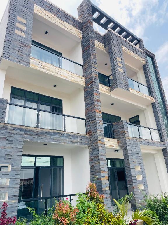 an exterior view of a building with large windows at Kigali Clever stay Villaa in Kigali
