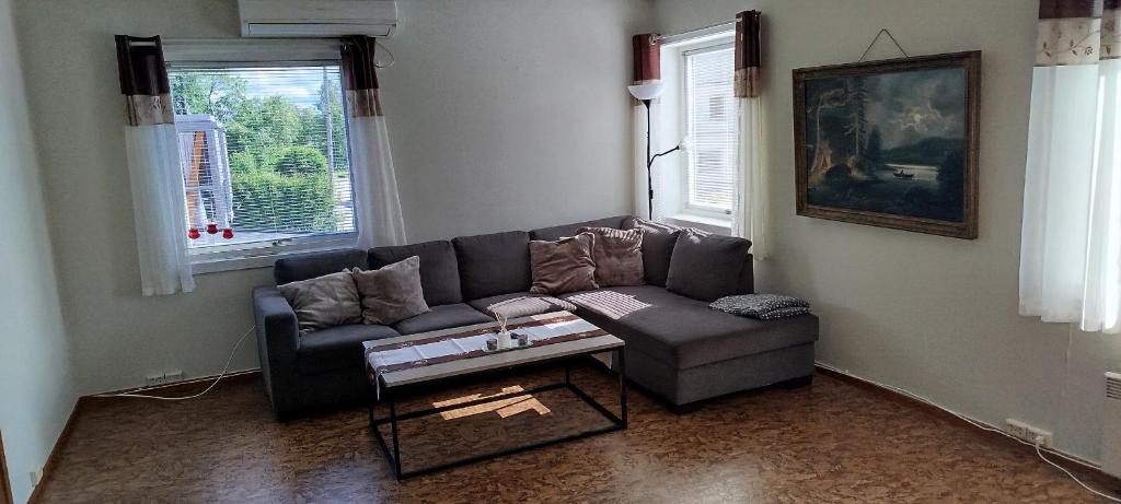 a living room with a couch and a coffee table at Eina house near the E4 road in Eina