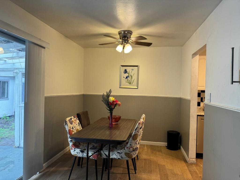 a dining room table with chairs and a ceiling fan at BM master suite in Mountain View in Mountain View