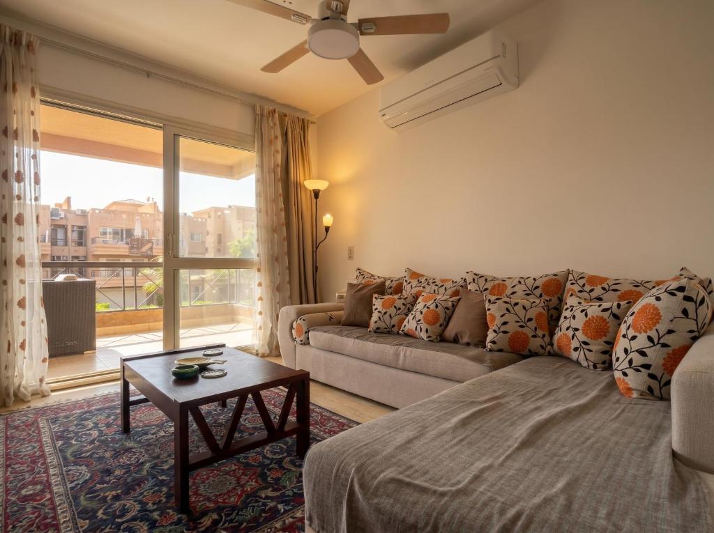 a living room with a couch and a large window at 396 Blumar Chalet North Coast Sidi-abdelrahman families & couples only in El Alamein