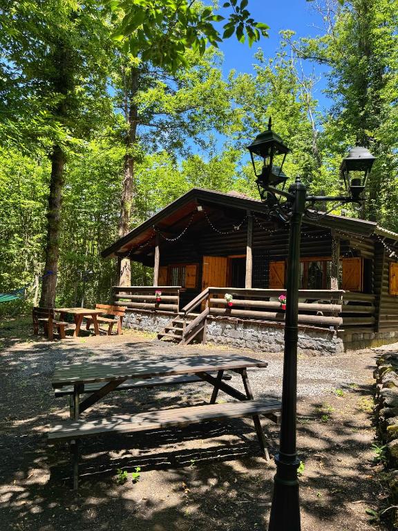 a picnic table and a light pole in front of a cabin at Etna Essence Chalet in Trecastagni