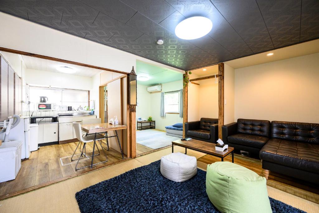 a living room with a couch and a table at yadobankkukomae19 in Fukuoka