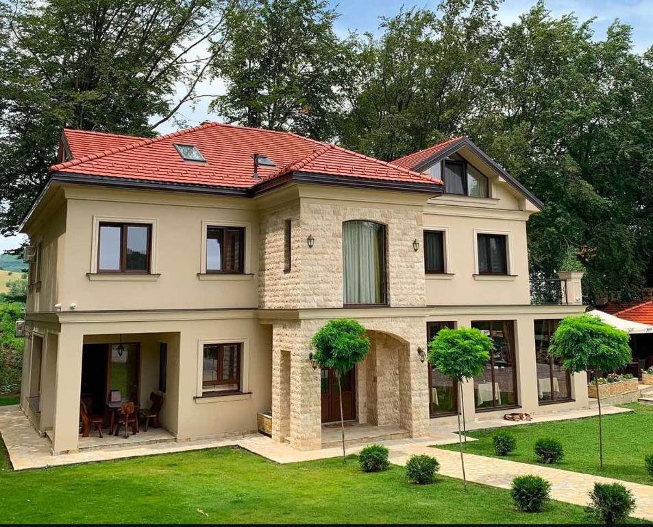 a large house with a red roof at Rajacki konaci in Polom
