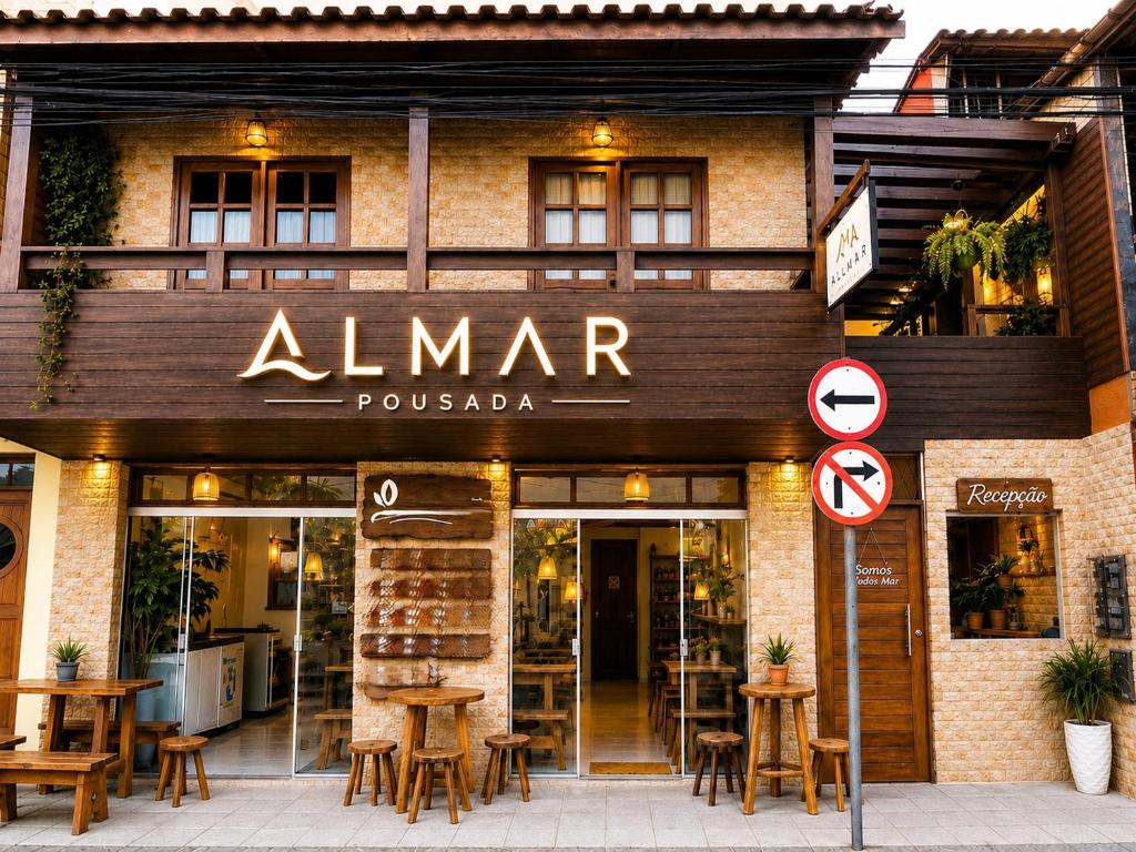 a restaurant with a sign on the front of it at Pousada Almar in Itacaré