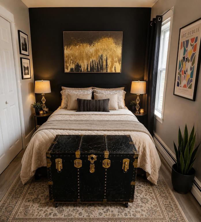 a bedroom with a large bed with a black wall at Cozy One Bedoom apartment in Saint John